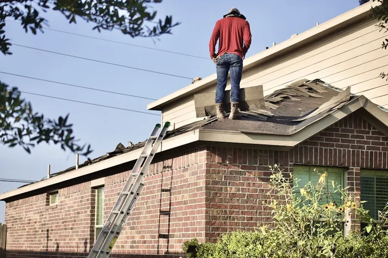 Professional roofer working on a residential roof in New Trier